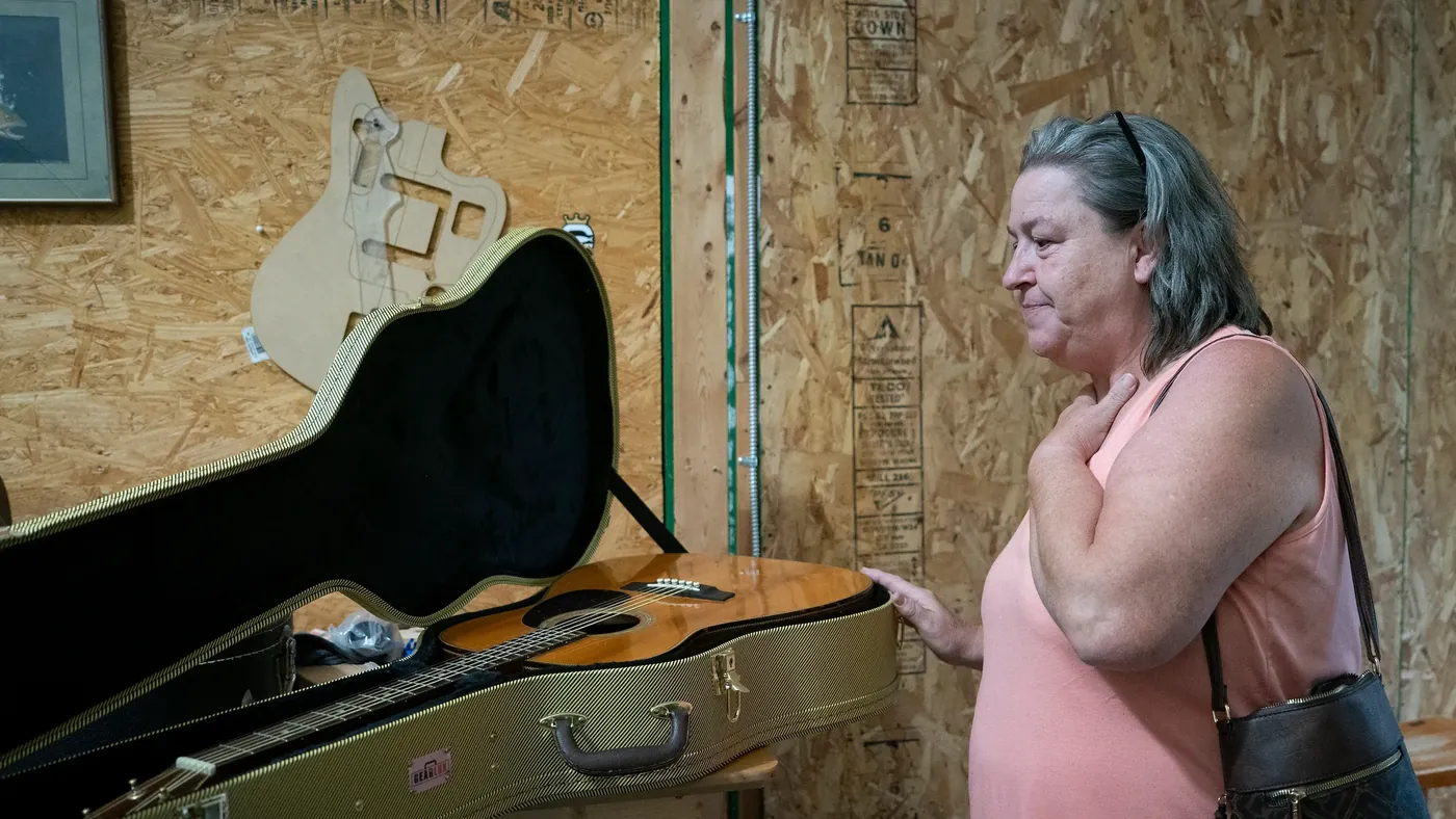 A musician receiving a donated guitar from ReString Appalachia